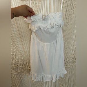 White Fashion Nova mini linen dress, tie strap around the waist, zips, ruffle